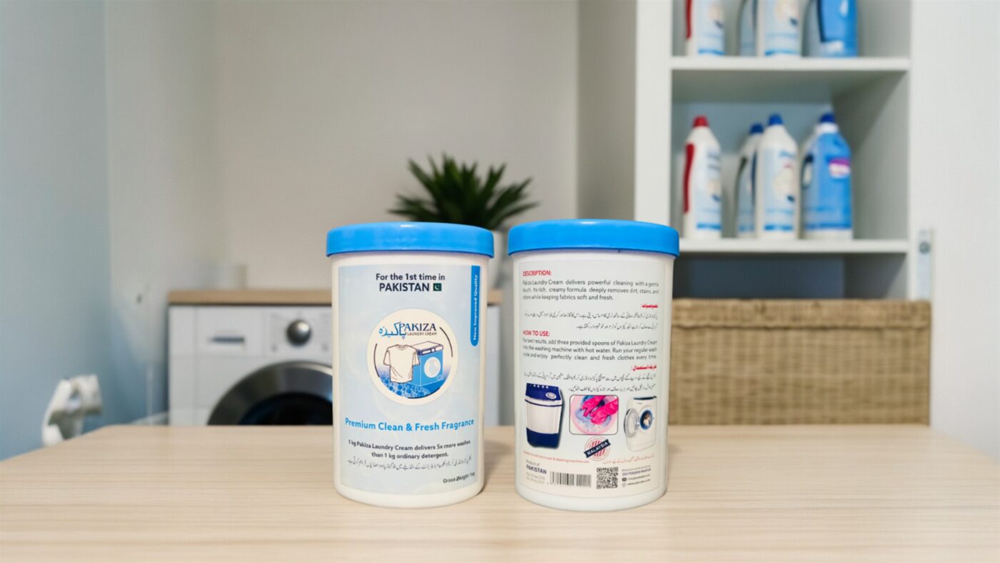 Two Pakiza Laundry Cream tubs showing the front and back labels beside a washing machine